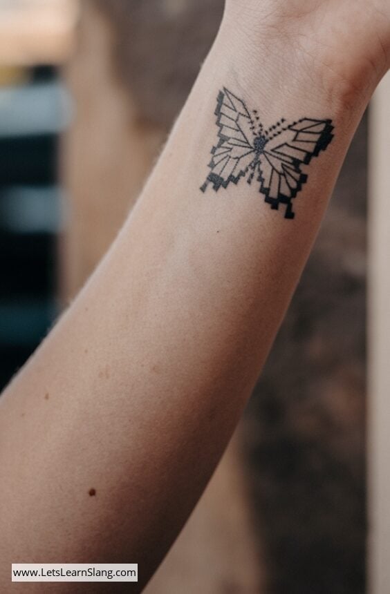 Pixelated Butterfly Wrist Tattoo