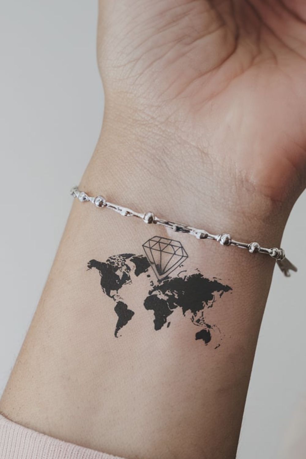 Diamond World Map Wrist Tattoo